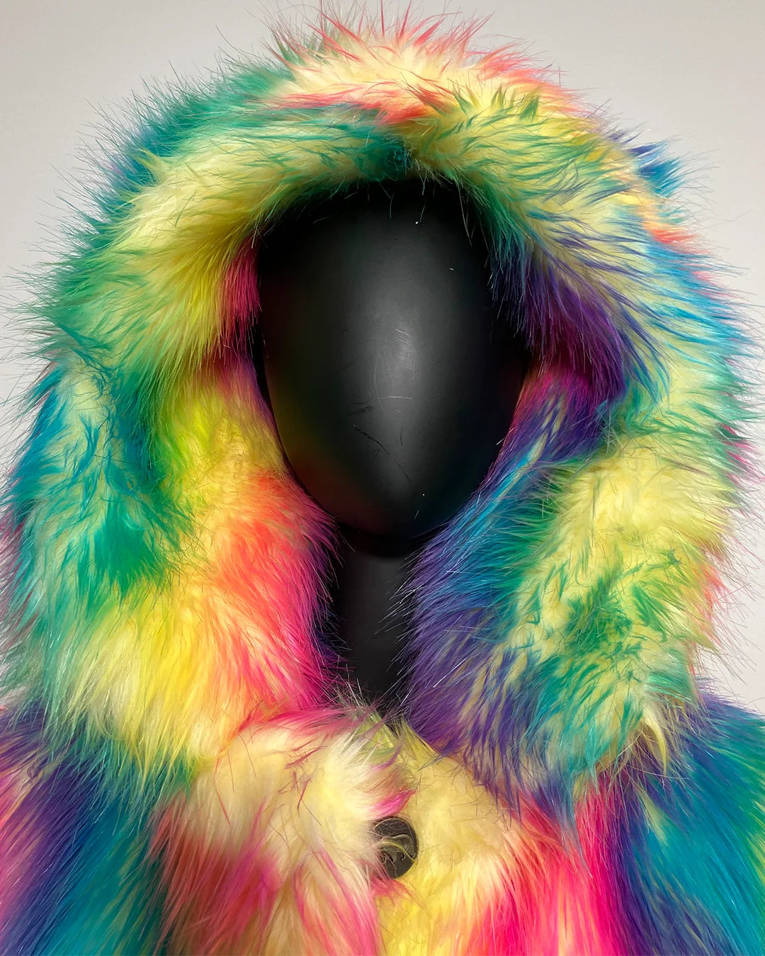 Mannequin wearing a colorful fur coat with a white background