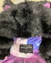 Black fake fur coat with pink/blue/purple galaxy printed liner and Spirithoods Neck label on a beige background