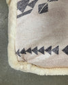Close-up of a textured fabric with geometric pattern on a gray surface