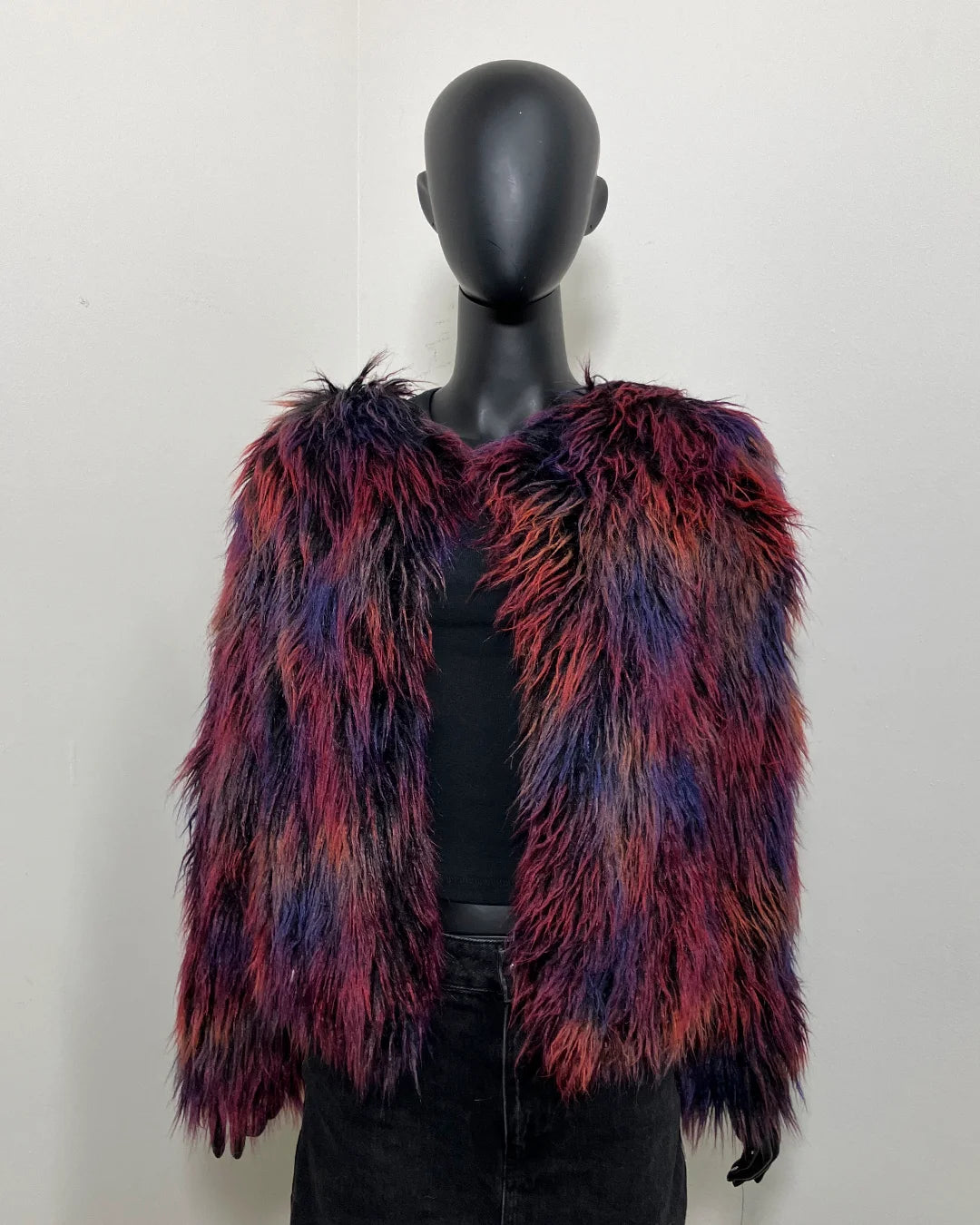 multicolor faux fur bomber jacket on a mannequin against white background