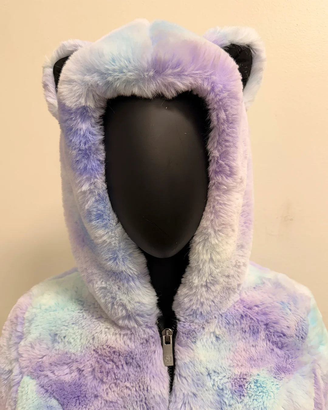 Multicolored fleece hoodie with cat ears on a beige background
