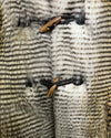 close-up photo of the toggle button closure on the front of the faux fur vest. SpiritHoods Online Sample Sale Style: Hooded Faux Fur Vest in Alaskan Hawk - Size Medium.