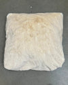 White pillow with brown stains on a gray background