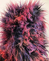 Close-up of a multicolored plush fake fur vest's oversized hood with pink, purple, and red hues.