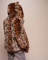 Leopard print fur-free fur coat with hood and ears, worn by a man facing away from the camera with the hood up on a plain background. SpiritHoods Custom Made Fall Winter Made to Order Coats in Animal Print and Plush Fake Fur