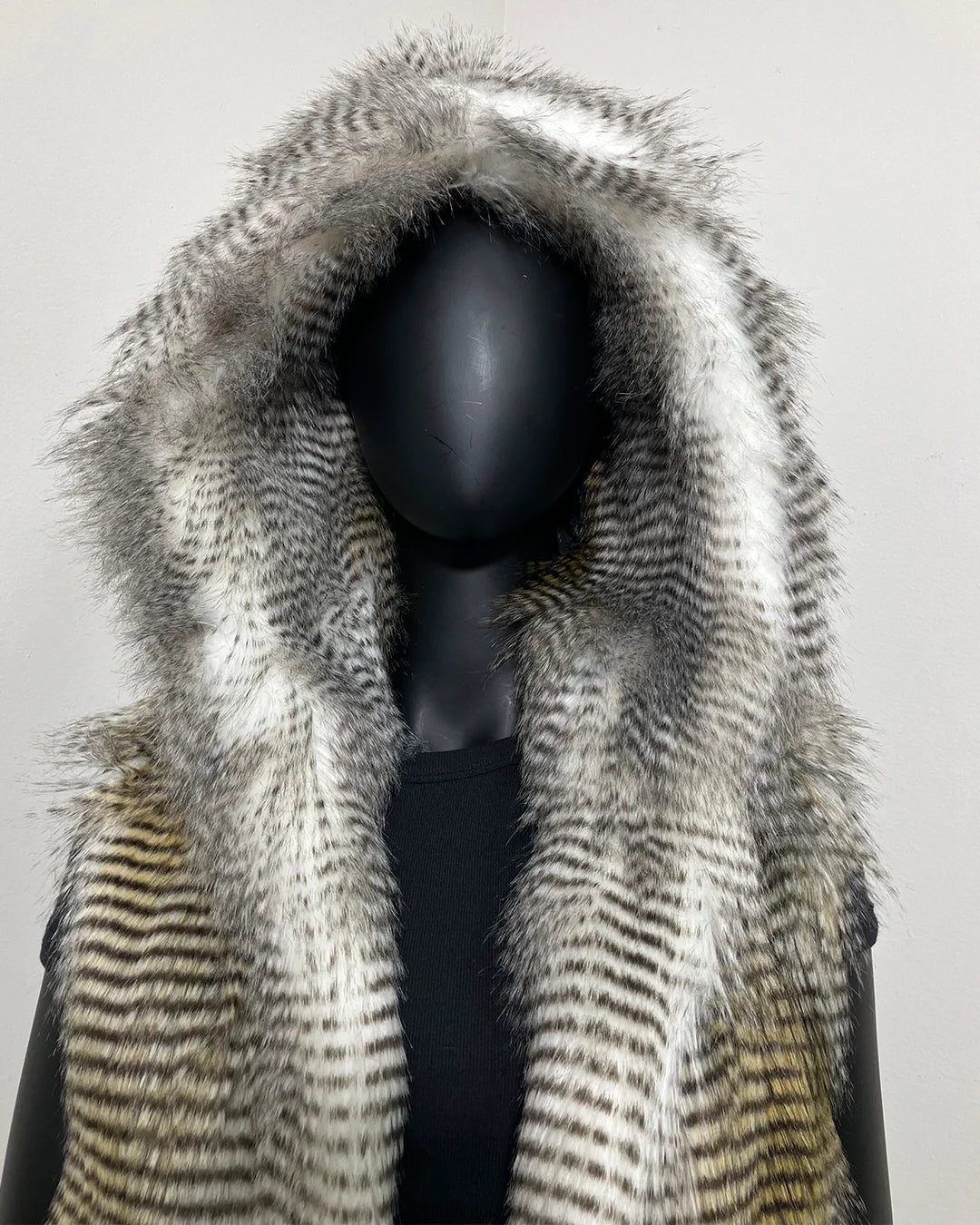 close-up photo of the SpiritHoods Online Sample Sale Style: Hooded Faux Fur Vest in Alaskan Hawk - Size Medium. show casing the large oversized hood and hawk inspired fake fur.