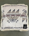 Decorative pet bed/pillow with geometric pattern on a plain background