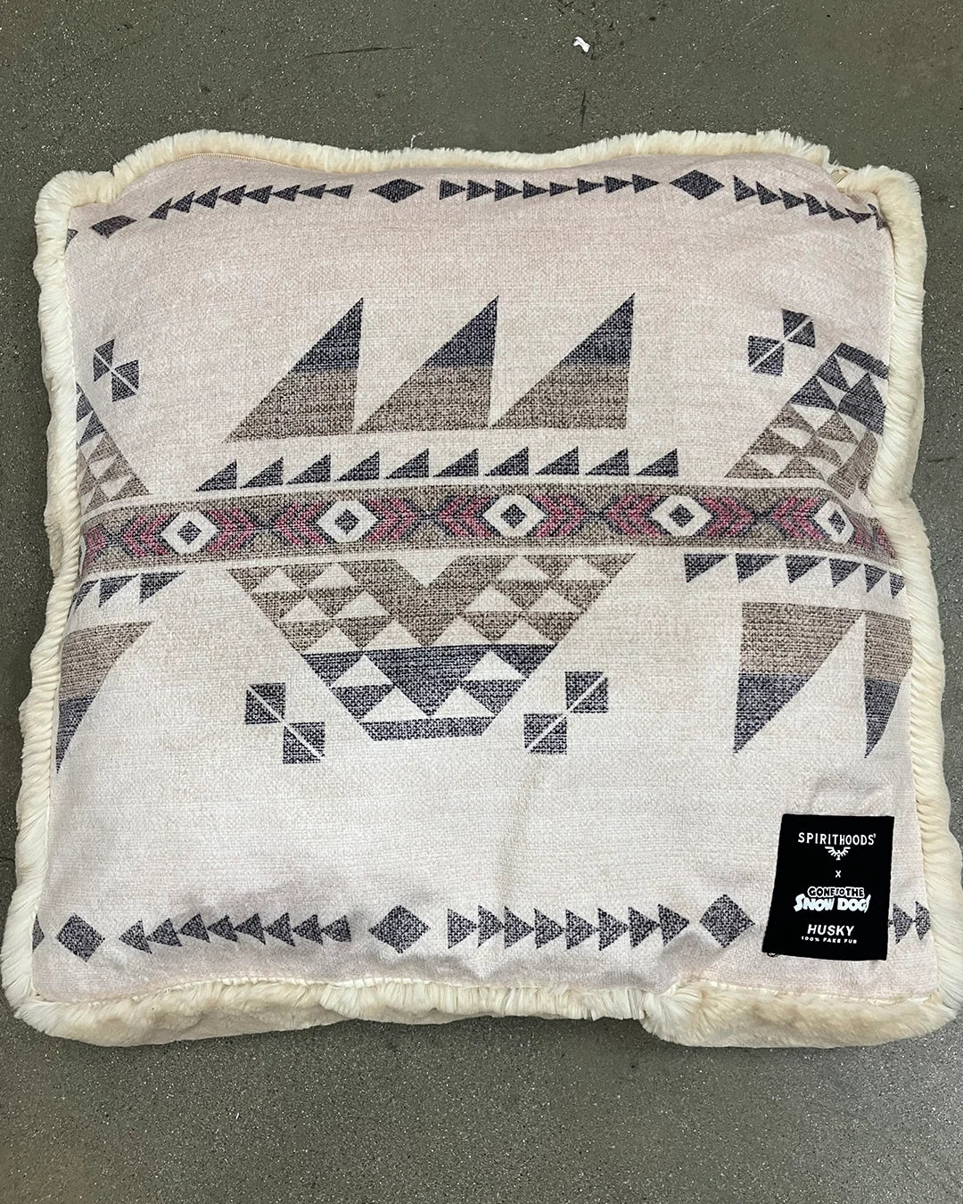 Decorative pet bed/pillow with geometric pattern on a plain background