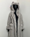 mannequin against a white wall, wearing spirithoods silver faux fur robe in Grey Fox