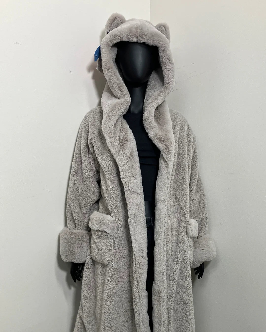 mannequin against a white wall, wearing spirithoods silver faux fur robe in Grey Fox