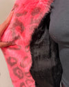 Close-up of a pink fake fur coat with leopard print - showing the inner faux snake skin liner aned inner zipper pocket