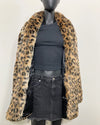 Mannequin wearing a leopard print fake fur coat over a black outfit on a white background showing the relaxed fit and black poly-satin lining. SpiritHoods Online Sample Sale Faux Fur Coat in Leopard Print in Size MEDIUM.