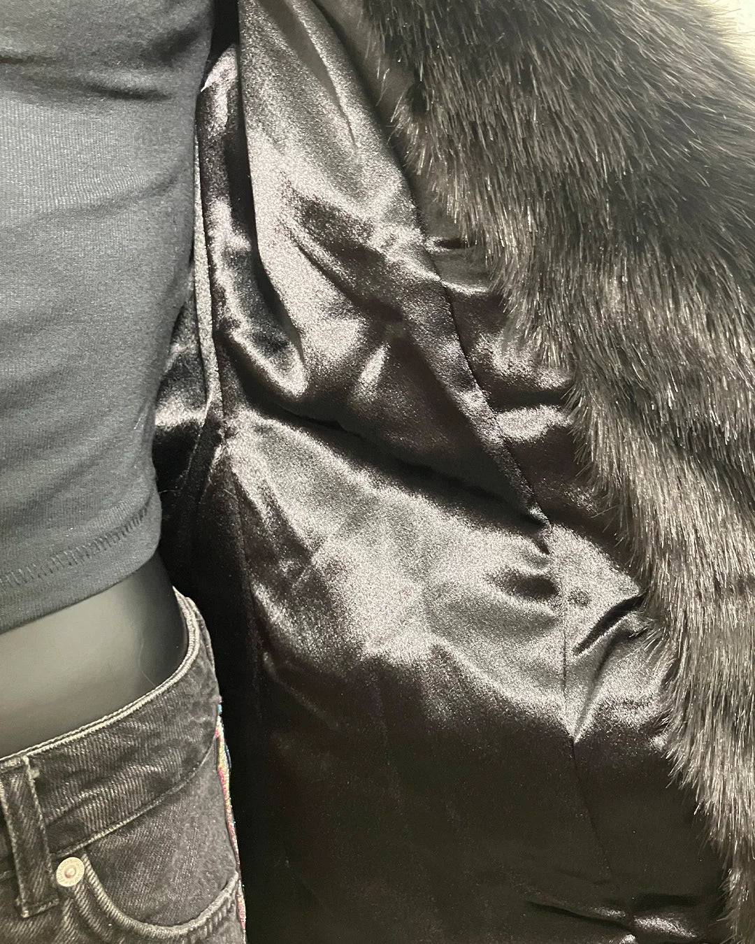 Close-up of the poly-satin black lining in the Black Panther Classic Faux Fur Coat in size SMALL