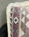 Close-up of a textured fabric with geometric pattern on a plain background