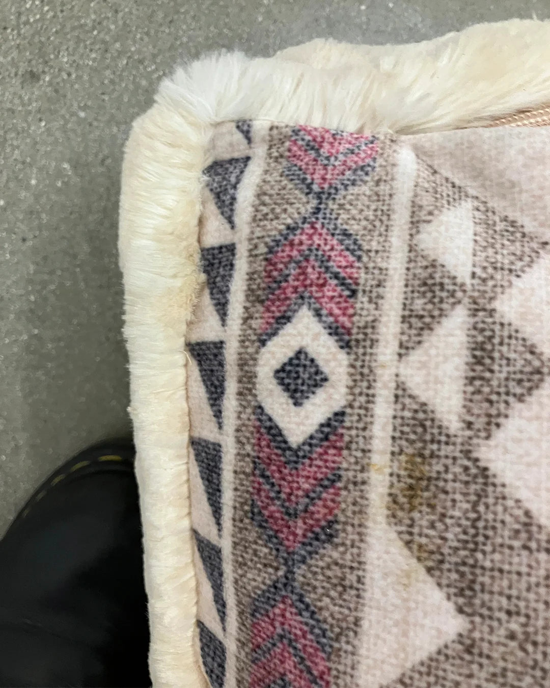 Close-up of a textured fabric with geometric pattern on a plain background