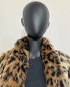 close-up photo of the leopard faux fur coat collar being worn down on the mannequin. SpiritHoods Online Sample Sale Faux Fur Coat in Leopard Print in Size MEDIUM.