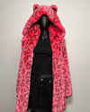 Mannequin wearing a bright pink leopard print faux fur coat with a hood on a plain background