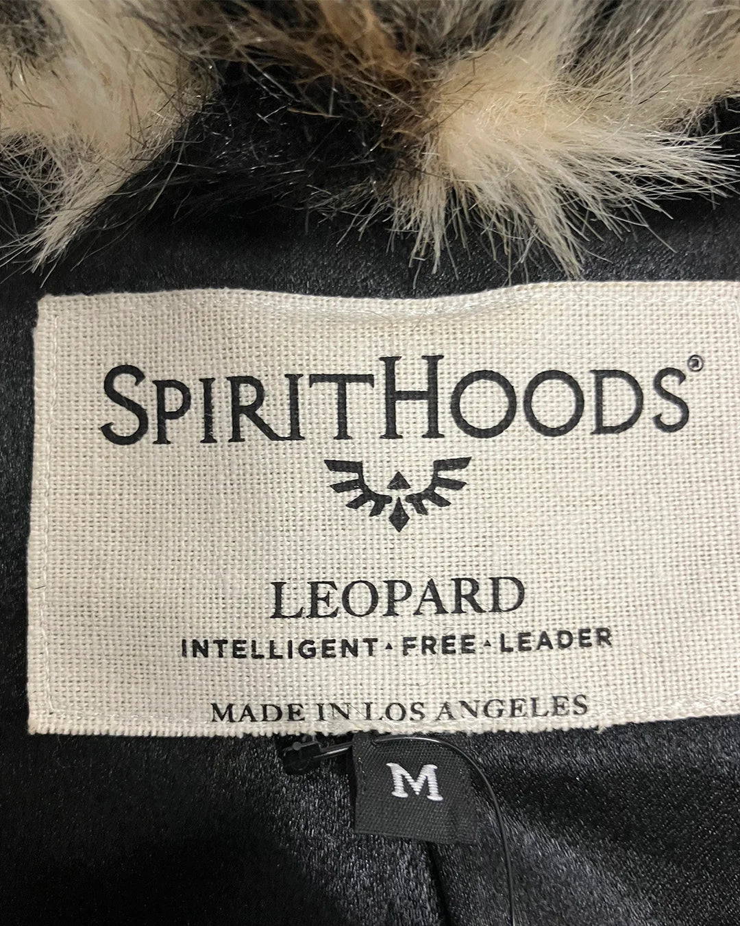 close-up of SpiritHoods Made in Los Angeles neck label for the Leopard Faux Fur Coat in size MEDIUM