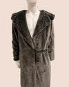 Mannequin wearing a gray fake fur wrap coat with a hood on a plain background