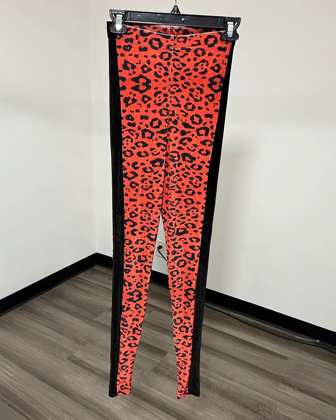 Orange and black Cheetah print leggings with black side panels running down the sides.