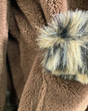 close-up photo of the brown body fabric of the leopard short robe with faux fur trim on the pocket