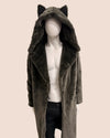 Mannequin wearing a dark grey faux fur wolf coat with wolf ears on a beige background