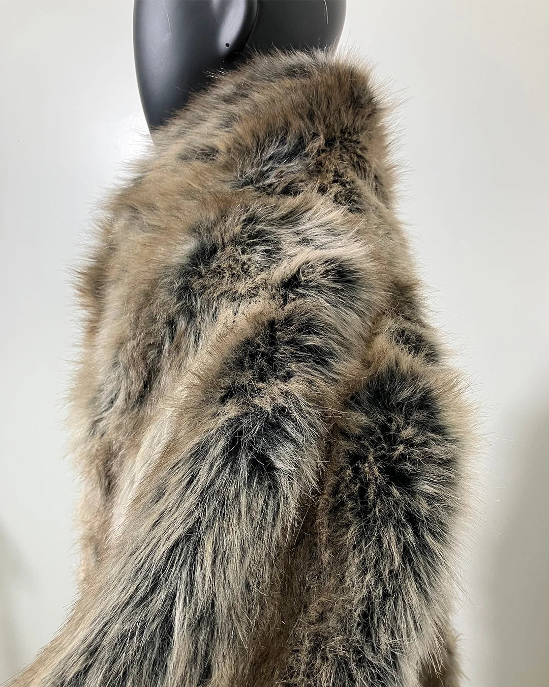 Fake Fur coat on a mannequin against a plain background