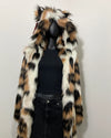 Mannequin wearing a fake fur coat with a hood and feline ears on a plain background