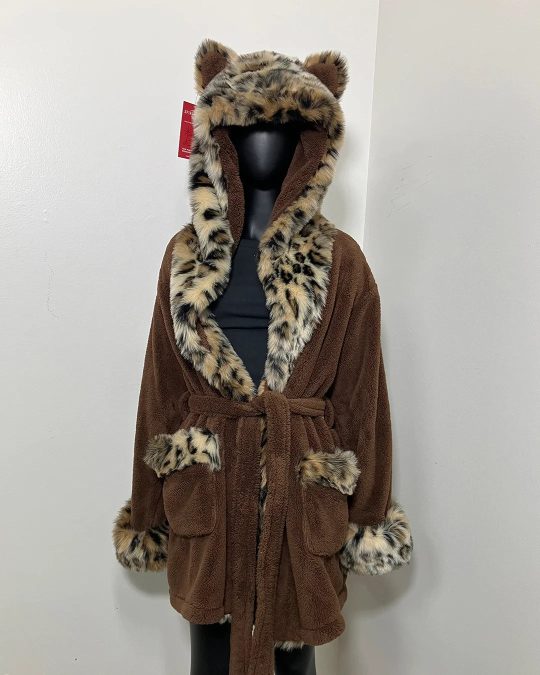 black mannequin wearing spirithoods short leopard robe on a white background