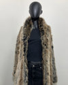Mannequin wearing a grey fake fur coat with a plain background