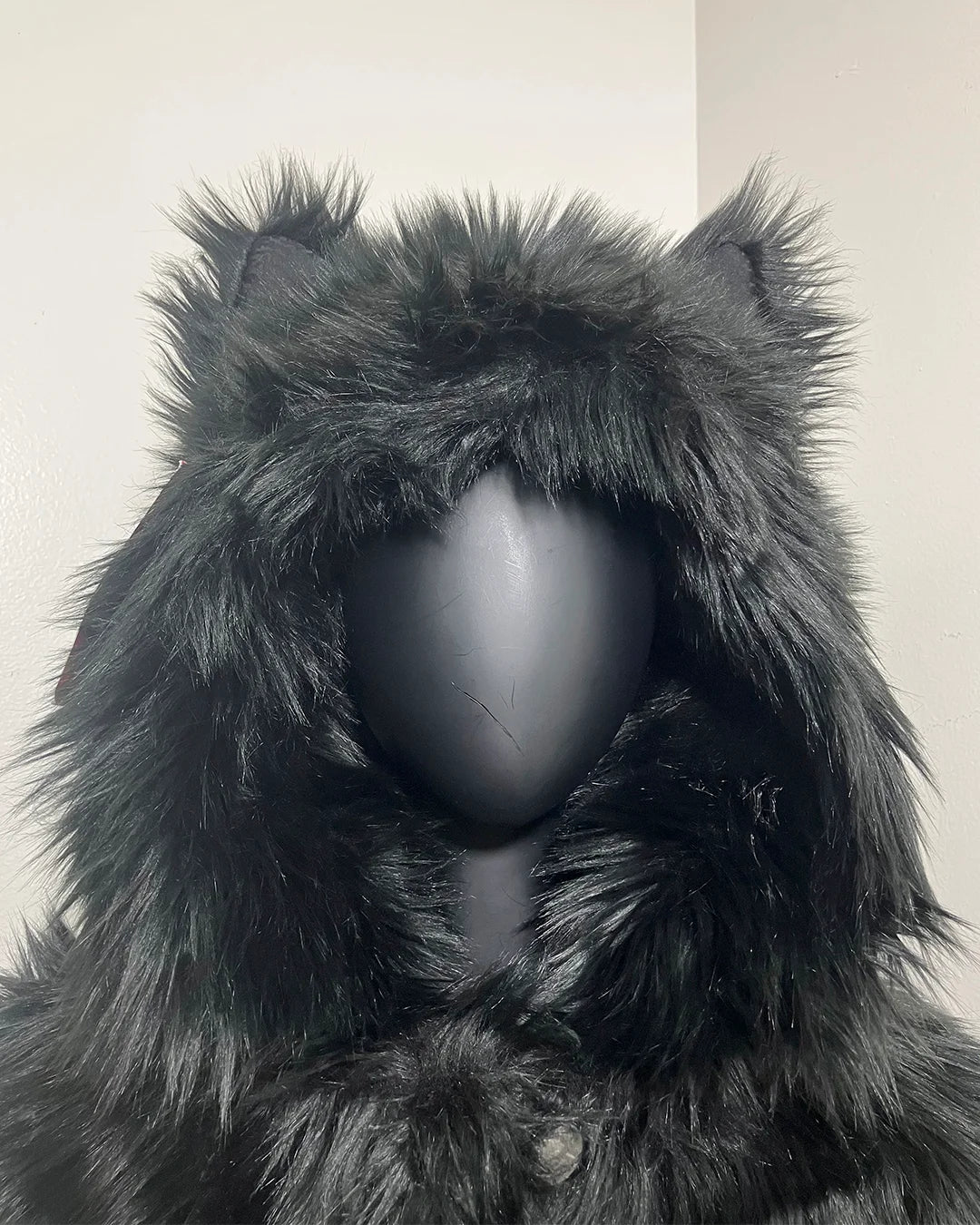 Close up photo of the SpiritHoods XXS Sizing Black Wolf Online Sample Sale Style hood and ears, against a plain background