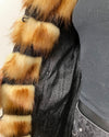 Close-up of a faux fur coats inner liner showing the black fabric with a light snakeskin print, and inner zipper pocket.