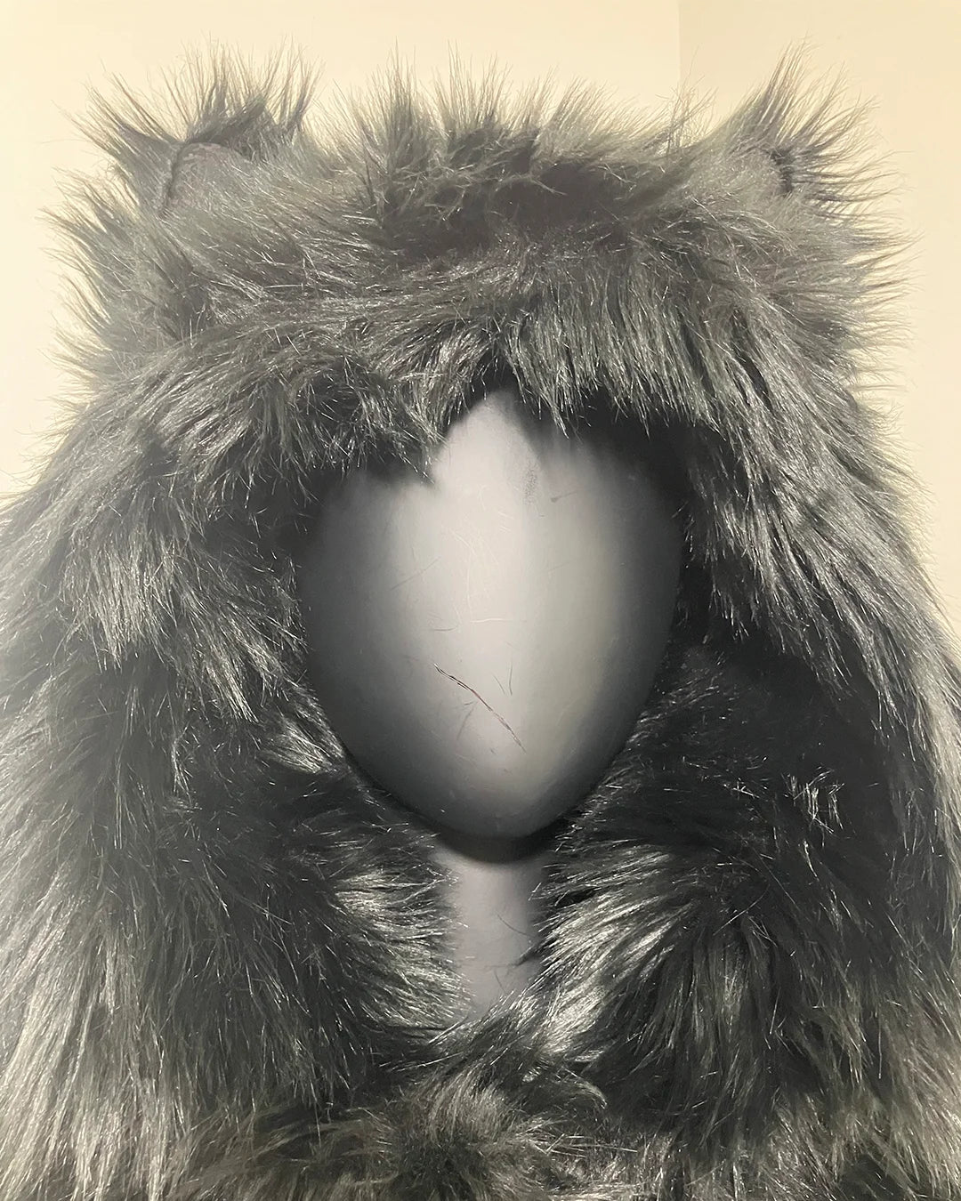 Close-up of a fluffy, black-colored hood with wolf ears, slightly choppy fake fur cut at wearers front center of hood. SpiritHoods XXS Sizing Black Wolf Online Sample Sale Style
