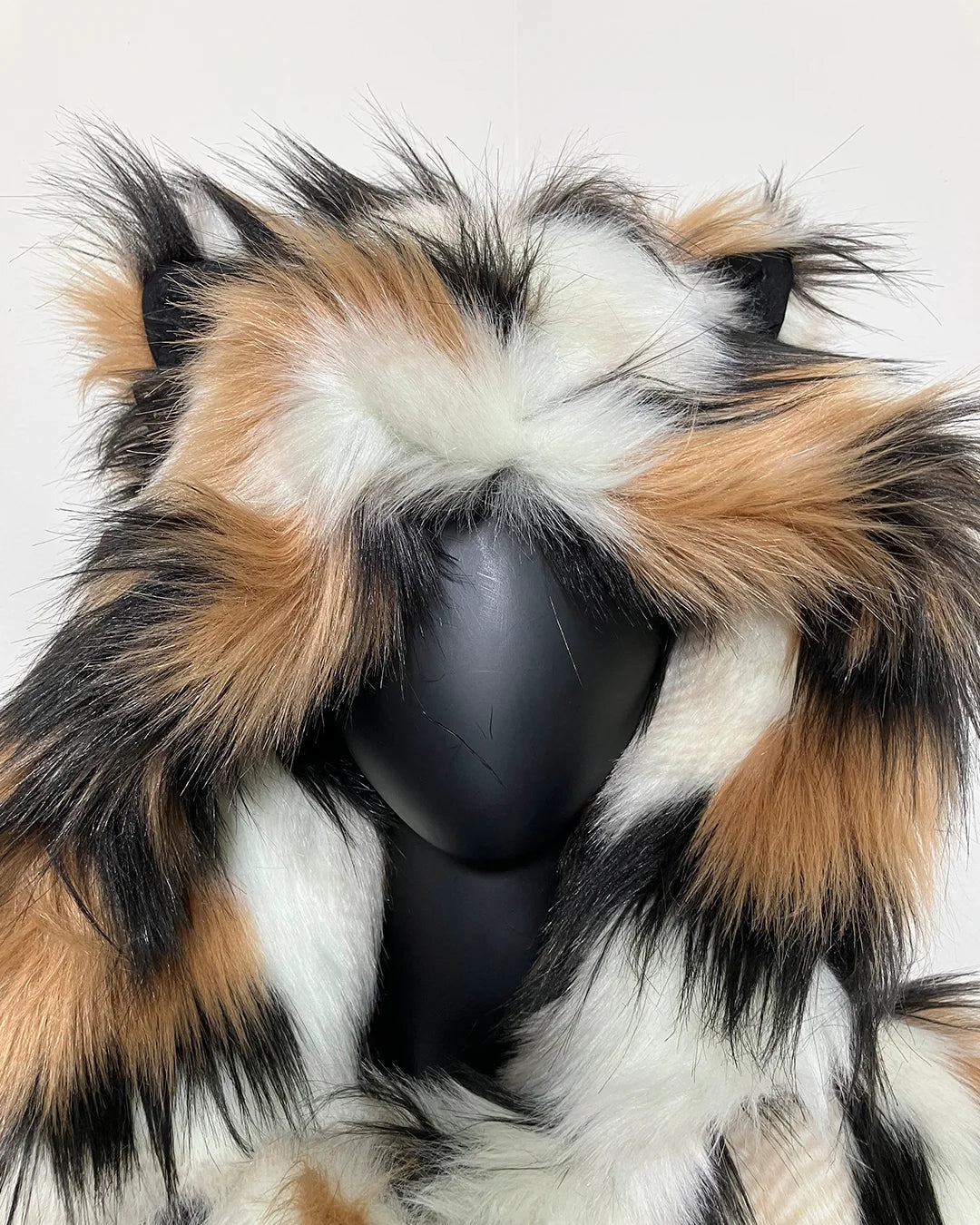 Multicolored faux fur hood in SpiritHoods Manx Cat Fake Fur - showing an upclose photo of the oversized hood + feline ears with black lining.