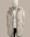 Mannequin wearing a fluffy pink fake fur stole against a plain background
