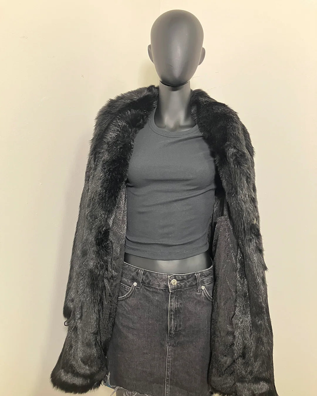mannequin wearing SpiritHoods Black Panther Faux Fur Coat with Collar - showing the all black lining with snakeskin inspired print + inner welt pocket, and inner zipper pocket. 