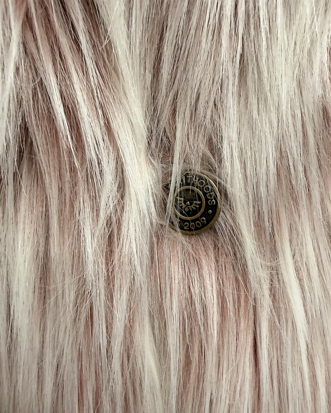 Close-up of spirithoods branded button on the one of a kind classic faux fur galah wolf coat