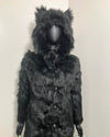 Black faux fur coat with hood on a white background, showing the slight creasing throughout this xxs sample sale coat style