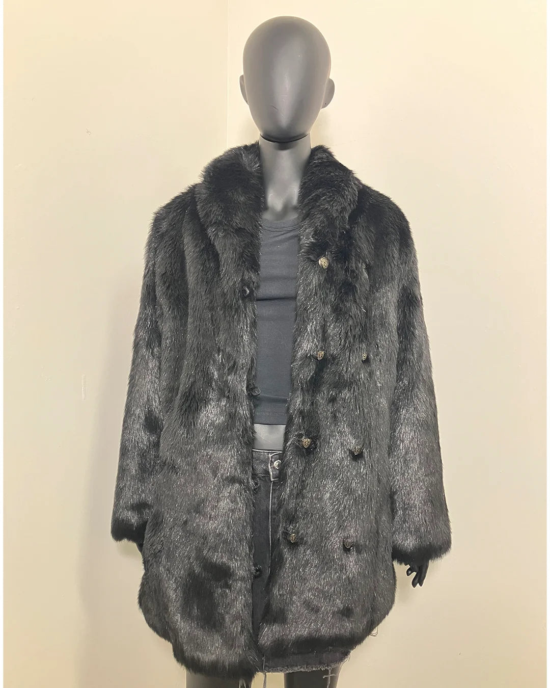 Mannequin wearing a black faux fur coat on a beige background buttons are not being used, you can see the peacoat button rows and button loops. SpiritHoods Online Sample Sale Style: Collared Faux Fur Coat in Black Panther - Size MEDIUM.