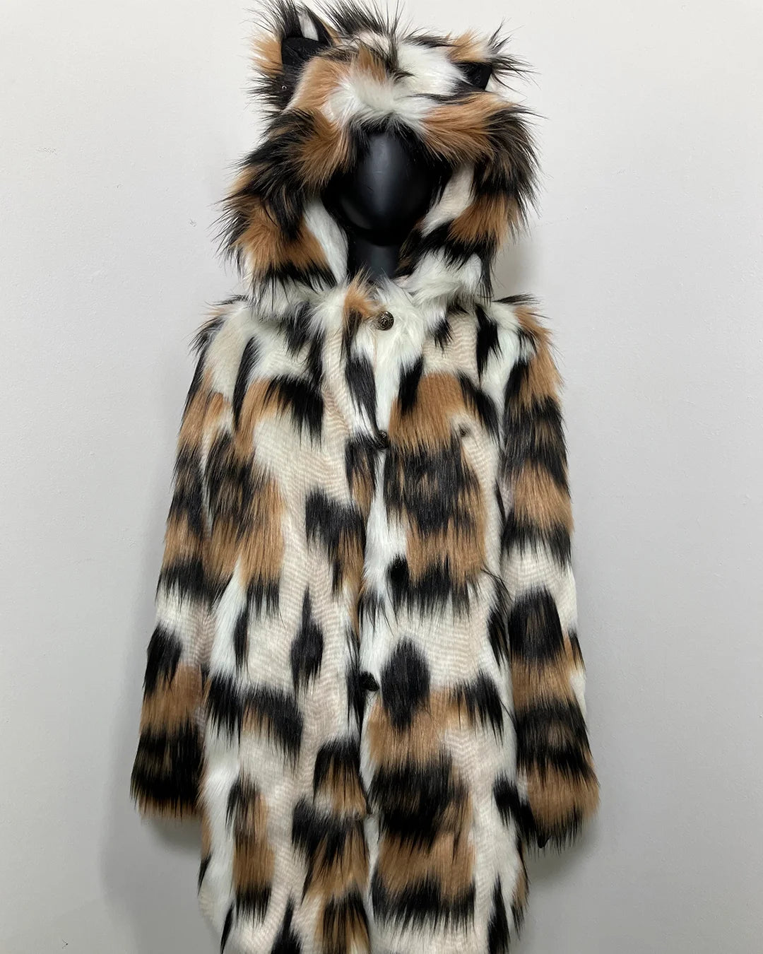Faux fur coat with a hood featuring a pattern of black, brown, and white on a light gray background.