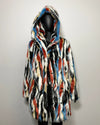 Multicolored faux fur coat on a mannequin against a plain background