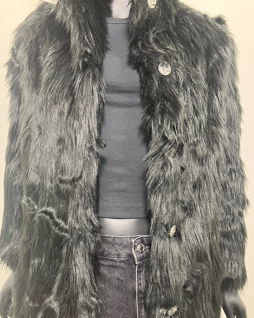 Mannequin wearing a faux fur black coat over a plain background close up of the wolf face buttons and peacoat button closure. SpiritHoods XXS Sizing Black Wolf Online Sample Sale Style