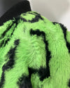 close-up photo of the neon green leopard faux fur bomber jacket where some of the fabric is splitting near the seams