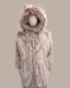 Pink faux fur coat with hood on a mannequin against a beige background