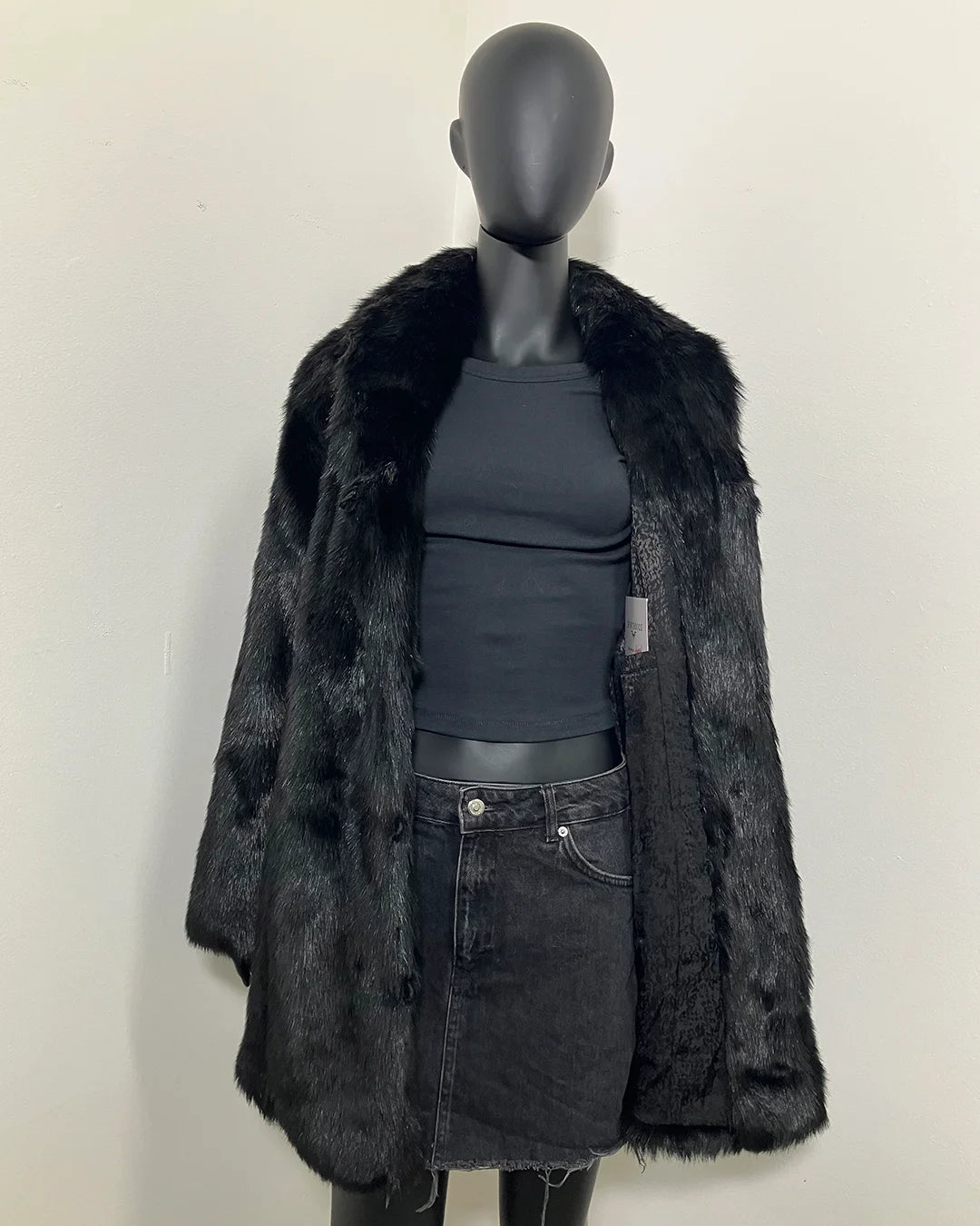 Mannequin wearing a black collared faux fur coat with black lining and inner welt pocket showing. SpiritHoods Online Sample Sale style Black Panther Faux Fur Coat in MEDIUM