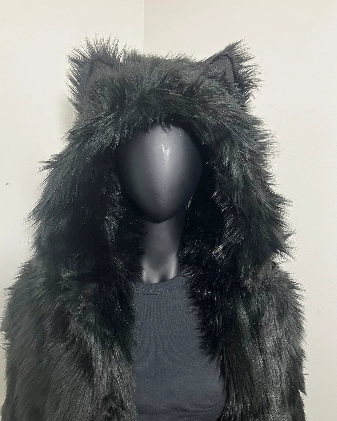 Mannequin wearing a black plush faux fur coat with an oversized hood with wolfears, against a plain background. SpiritHoods XXS Sizing Black Wolf Online Sample Sale Style