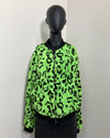 black mannequin wearing a neon green leopard faux fur bomber jacket against a white wall