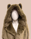 green faux fur coat with large oversized hood with wolf ears on a mannequin against a beige background