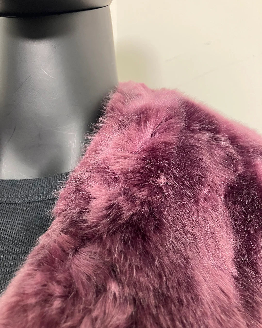 Close-up of a lavender purple faux fur coat on a mannequin - where the faux fur meets the seams some density issues. SpiritHoods Online Sample Sale Style: Luxe V-Neck Faux Fur Coat in Lavender Wolf in Size X-SMALL.