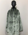 Green faux fur coat on a mannequin against a white background